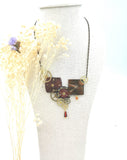 "Magellan" necklace with burgundy-red dial
